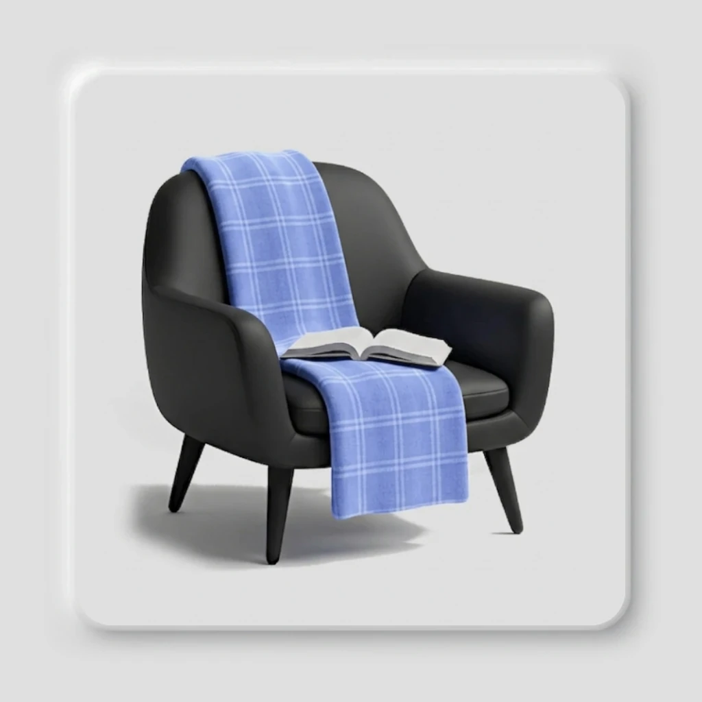 Image d'un fauteuil noir avec un plaid bleu et un livre ouvert, illustrant l'espace d'introspection et de réflexion sur la psychologie de l'écrivain et son mode d'existence.